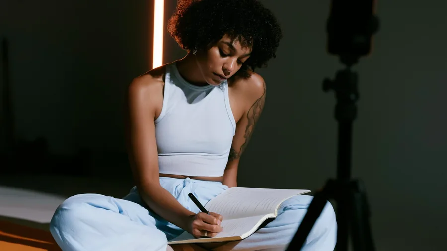 Cover: a creator sitting cross-legged on a mat, planning a session